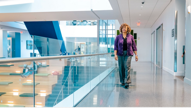 Debra Neblett, a UNCG alumni, walking in building